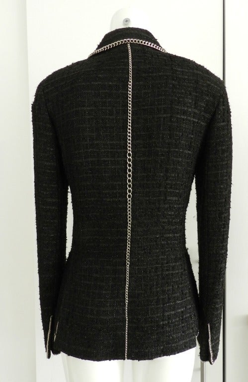 Chanel Spring 2006 black jacket with silver metal chain trim. Fastens at centre front with one hook and eye closure. Tagged size Chanel 38 (USA 6). Actual garment bust 36, recommended for 34