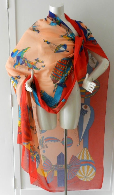 Hermes large cotton beach pareo for sarong or shawl. Measures 57 x 66 inches. Whimsical hot air balloon scene in red, peach and turquoise tones. Excellent condition. Signed Hermes within the print. Secondary white tag has been removed.

Shipping