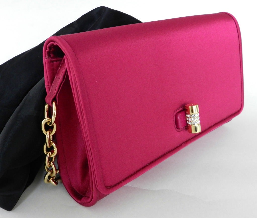 Tom Ford for Yves Saint Laurent fuchsia silk satin evening bag. Goldtone metal turn clasp is mounted to a leather base and decorated with clear rhinestones. Original cards and duster. Excellent condition - used a few times. Body measures 8.5 x 5 x