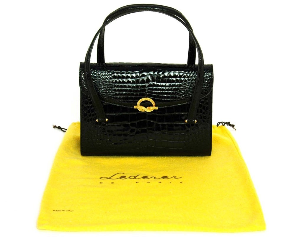 Lederer Black Glazed Crocodile Leather Bag
Materials: Crocodile
Made In France
Three Compartments Inside with Two Slit Pockets and One Zipper Pocket
Closes with Snap Closure
Stamped: Lederer MADISON Ave at 58 st MADE IN FRANCE

Length: