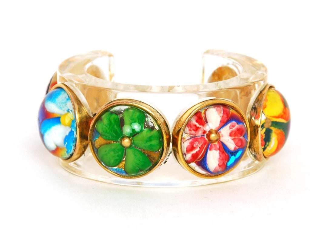 CHANEL resin cuff bracelet With Flower Bubble Accents

    Age: 1988
    Made In France
    Materials: Lucite, Gold Tone Metal, Flower Forms.
    Features Thick Transparent Lucite Cuff With Six Different Encased Flowers With Gold Borders.
   