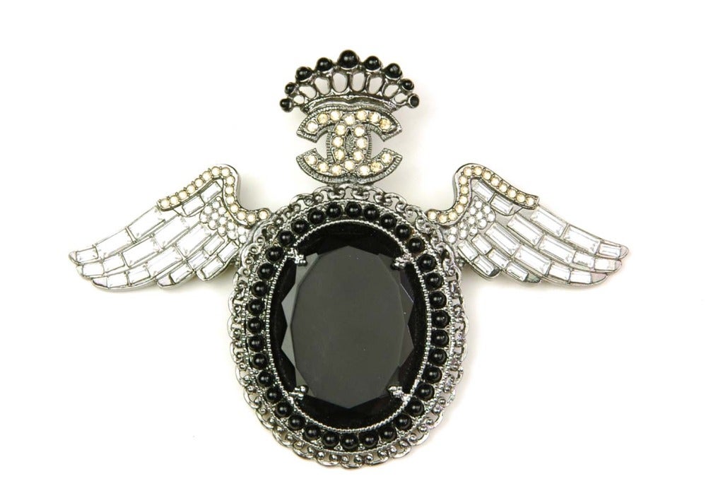 Chanel Black/Silver Oval Pin With Wings And Crown
Age: c. 2008
Made In France
Materials: Rhinestones, Beads
Stamped 
