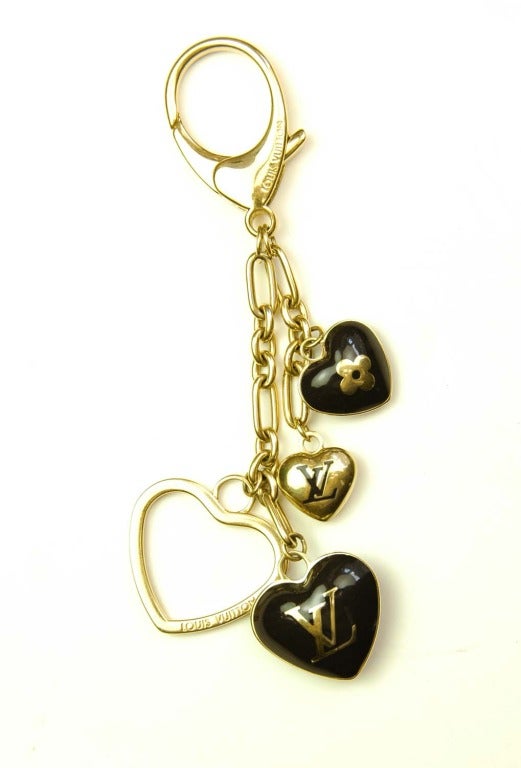 LOUIS VUITTON Monogram Heart Bag Charm/Key Chain

    Materials: Gold Tone Metal, Enamel Charms.
    Features 4 Different Danging Hearts With Signature Clover And Logos In Gold And Brown. Lobster Clasp. Can Be Worn As A Bag Charm Or Used As A Key