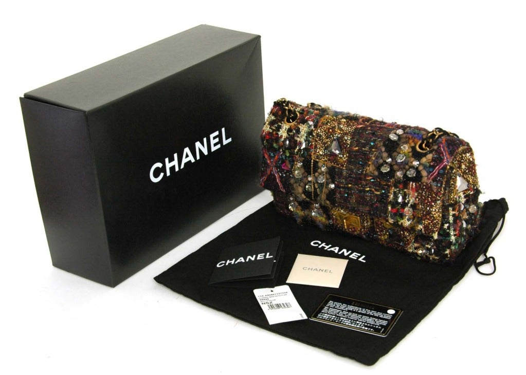 CHANEL 2011 Limited Edition Paris/Lesage Tweed Reissue 2.55 Flap Bag With Stones And Chain

Materials: Tweed, Lurex Thread, Yarn, Stones, Beads, Chain, Distressed Brass Hardware.

Features Multicolor Patchwork Design With Varied Embellishments