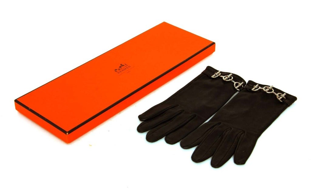HERMES Brown Leather Gloves With Silver Toggle Detail

    Made In France
    Materials: Leather, Silver Toggle Hardware
    Features Classic Soft Leather Glove With V-Shaped Wrist Opening On Underside And Silver Toggle Link Detail On Wrist.
  