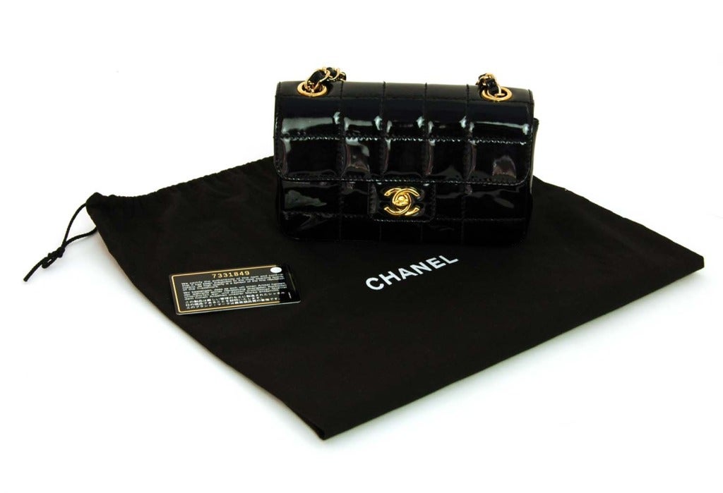 CHANEL Black Patent Chocolate Bar Quilted Mini Bag With Gold Hardware

    Age: c. 2002
    Made In France
    Materials: Patent Leather, Gold Hardware
    Features Chocolate Bar Pattern Quilted Patent Leather With Gold Hardware In Miniature