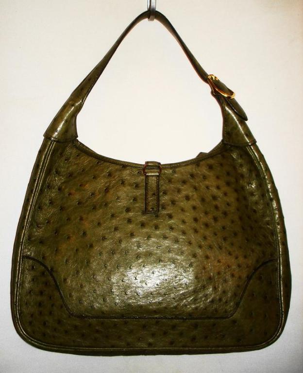 This HERMES Moss Green Ostrich Leather Trim Bag closes with a zipper closure and golden hook closure. Strap stamped with 