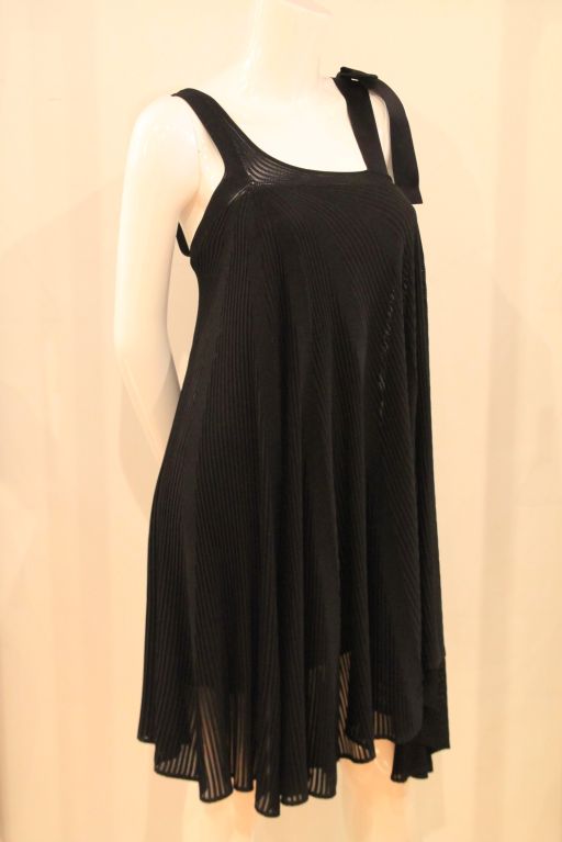 This CHANEL Black Knit Dress evokes the timeless and classic design of Chanel, and it is a perfect must-have for any occasion.<br />
<br />
Both flirty and classic, this dress features a silk ribbon bow & shoulder straps.  Comes with an under