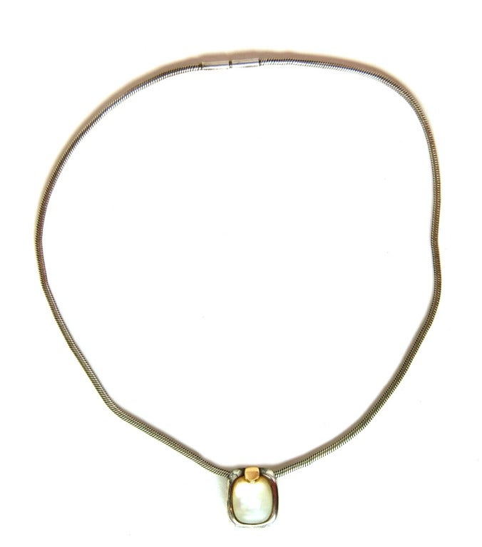 HERMES Mother of Pearl MOP Pendant On Sterling Silver Chain W. Gold Accent

Materials: Sterling silver, yellow gold, mother of pearl.
Features silver cable chain with spring-and-twist closure. Rectangular mother of pearl pendant with silver