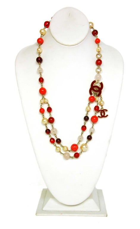 CHANEL Red/White Bead & Faux Pearl Belt/Necklace W. Hanging Logo CC Charms

Age: 2008
Made In France
Materials: Silver chain, faux pearls, beads, resin CC charms.
Features mixed beads including faux pearls, marbled pale red beads, transparent