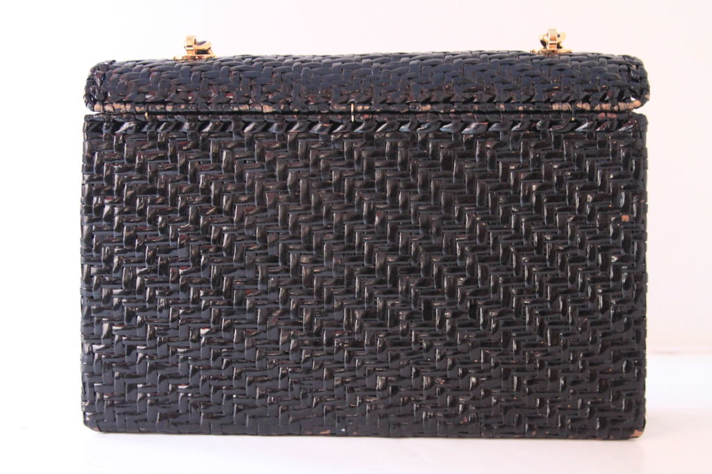 This rare, vintage CHANEL Black Raffia Classic Flap Bag evokes the timeless and classic design of Chanel.  It is a must-have for all Chanel collectors.<br />
<br />
The bag closes with goldtone 