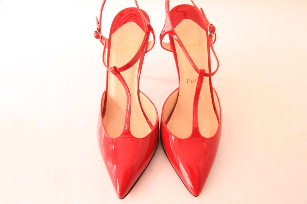 These stunning CHRISTIAN LOUBOUTIN Red Patent Pointed Toe Heels w/ Slingbacks are the perfect addition to anyone's wardrobe.  <br />
<br />
Closes with a slim hardware buckle fastening and patent strap closure.  Leather insole with “Christian 