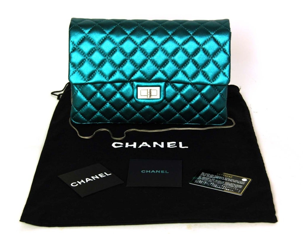CHANEL Metallic Turquoise Quilted Classic Reissue Clutch W. SHW & Skinny Chain Strap c. 2009

Age: 2009
Made in Italy
Materials: lambskin, brushed silver hardware, silver chain strap.
Features classic quilted chanel body with skinny silver