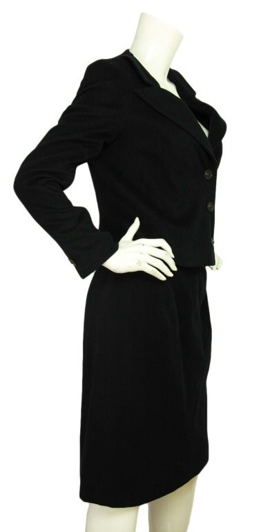 CHANEL Black Cashmere Jacket & Skirt Suit Set Sz. 42

Made in France
Materials: 100% cashmere. Jacket lining: 95% silk, 5% spandex. Skirt lining: 100% silk.
Features single breasted blazer with three logo leather snap buttons down the center.