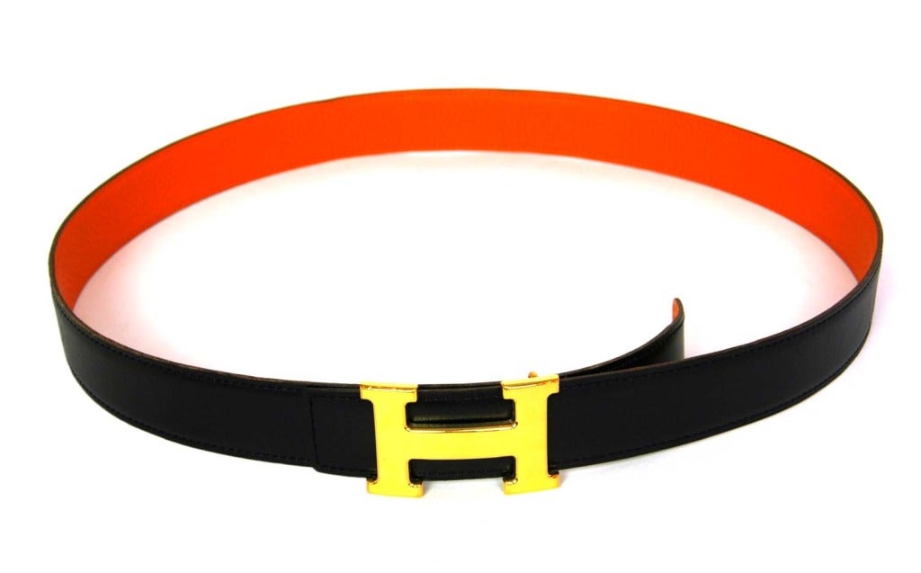 HERMES Gold Logo H Buckle W. Reversible Black/Orange Belt Sz. 95 2005

Age: 2005
Made in France
Materials: leather, goldtone hardware.
Features reversible leather belt in smooth black leather and pebbled orange leather with gold H