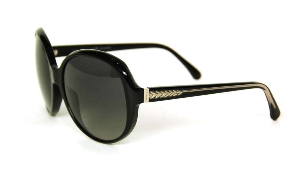 CHANEL Round Black Resin Polarized Sunglasses With Silver Arrowhead Design
Made in Italy
Materials: black resin, plastic frames, silvertone arrowhead detail.
Features round oversize sunglasses with silvertone arrowhead detail and CHANEL logo