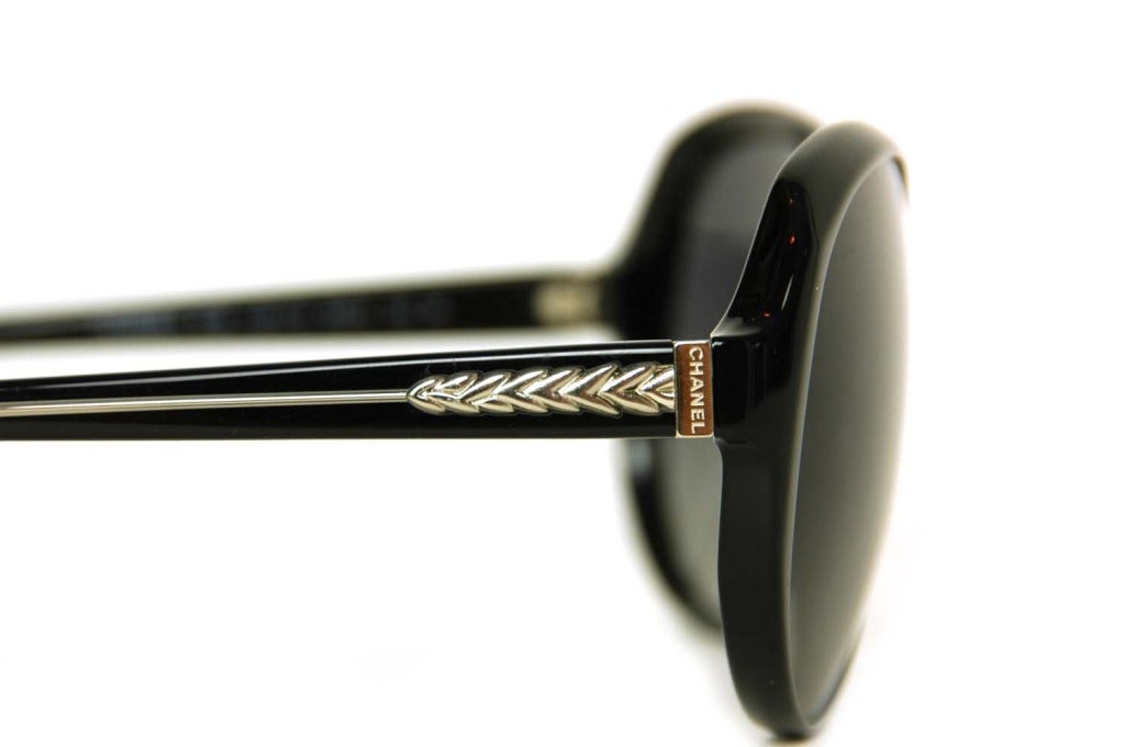 Women's CHANEL Round Black Resin Polarized Sunglasses With Silver Arrowhead Design