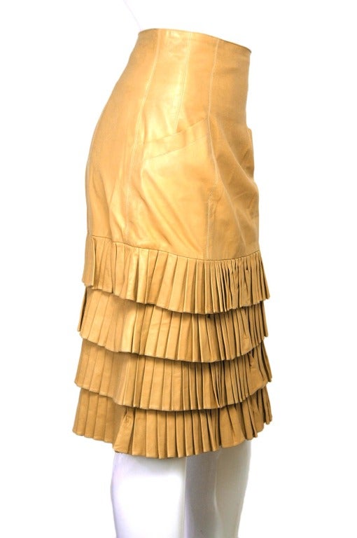 CHANEL Beige Accordion Pleat Trimmed Leather Skirt Sz. 38
Made in France
Materials: 100% calfskin, Lining: 100% silk, 100% nylon.
Features A-line skirt in soft leather with four tiers of accordion pleats from the bottom hem up. White stitching on