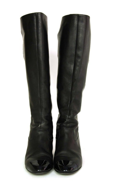 Chanel black leather boots w. back buckles & cut outs
Made in Italy
Materials: leather, patent leather
Closes with rear zipper and buckles
Features cut out design on the back

Marked size: 37

Estimated to fit US size: 6.5 - 7

Heel: