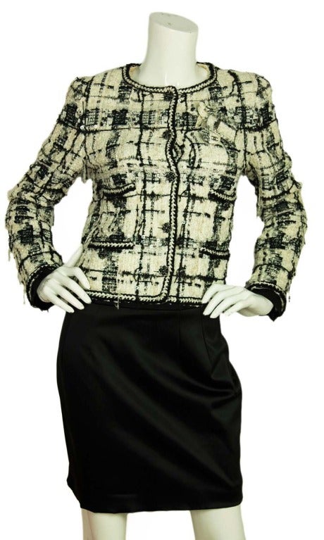 CHANEL Black & White Fantasy Tweed Jacket W. Sequins & 3 Detachable Pins c. 2006 Sz. 38

Age: c. 2006
Made in France
Materials: 30% nylon, 24% rayon, 14% metal, 9% cotton, 8% rayon, 8% polyester, 7% wool. Lining: 96% silk, 4% spandex.
Features
