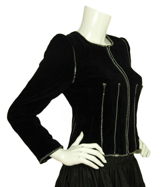 Made in France
Materials: 85% cotton, 15% metal. Lining: 96% silk, 4% spandex.
Features round neck blazer in black velvet with silver chain and bow design. Center zipper on front.

Marked size 40
Estimated to fit a US size 6/8
Shoulder: 13