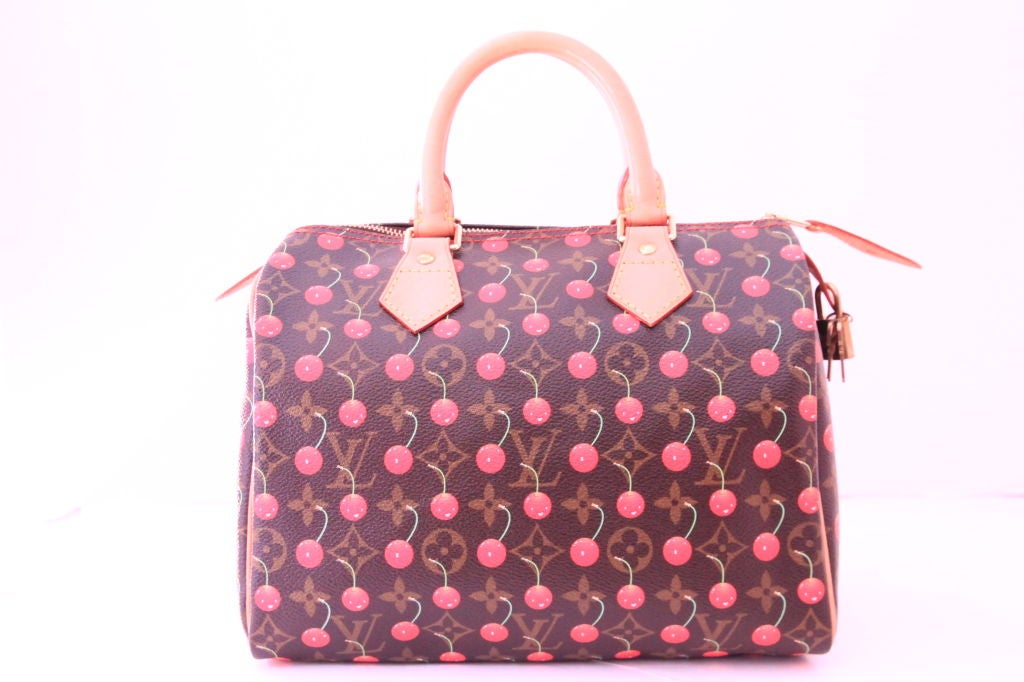 This Louis Vuitton limited edition Cerises Speedy 25 handbag is the must-have for all collectors. <br />
<br />
This Speedy was created by Takashi Murakami for Louis Vuitton.  Feautres monogram cerises canvas with smiling cherries over the classic