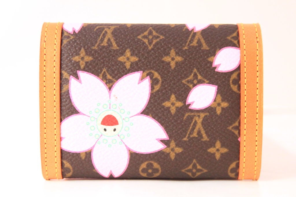 This Louis Vuitton limited edition Murakami Cherry Blossom flat coin purse wallet is the must-have for every collector.<br />
<br />
This flat coin purse wallet was created in 2003 by Takashi Murakami for Louis Vuitton.  Feautres monogram canvas