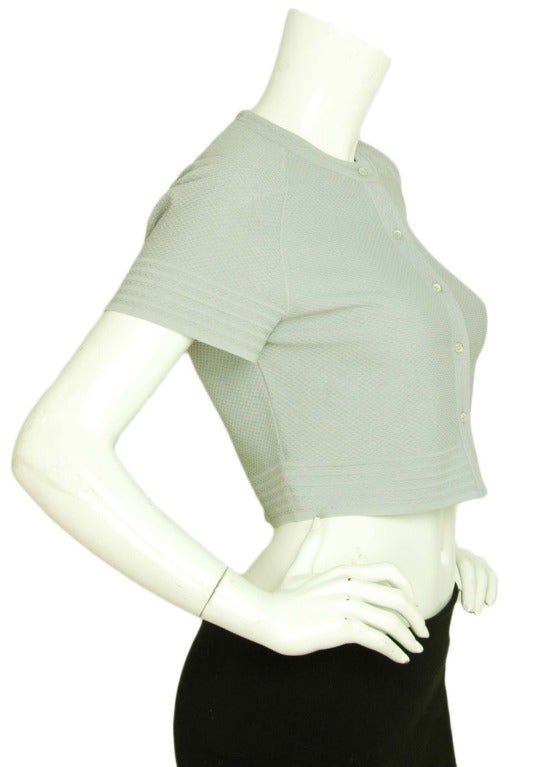 Alaia Grey Cropped Short Sleeve Cardigan
Made in Italy
Materials: viscose, polyester
Closes with front buttons

Measurements:

Marked size: large
Shoulder: 16