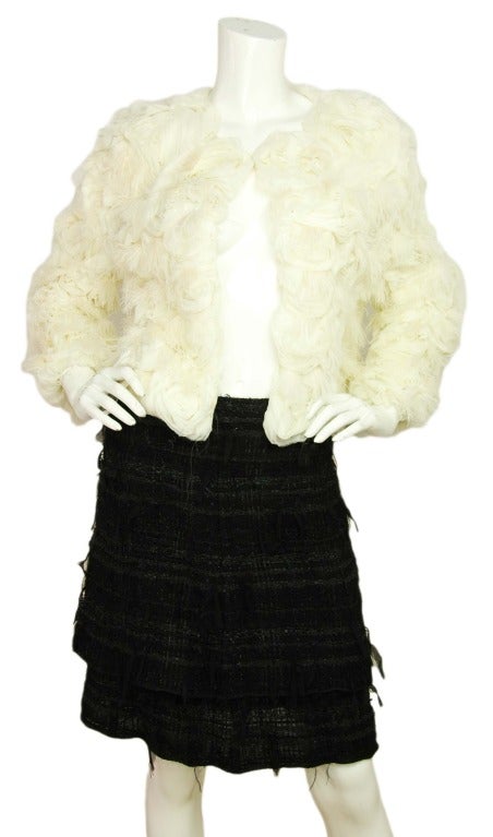 VALENTINO White Silk Bolero Jacket With Rosettes & Feathers RT. $3350
Materials: silk, feathers, satin lining.
Features round neck bolero jacket covered in silk rosettes and white feathers. Hook and eye closure at the top.

Size tag is