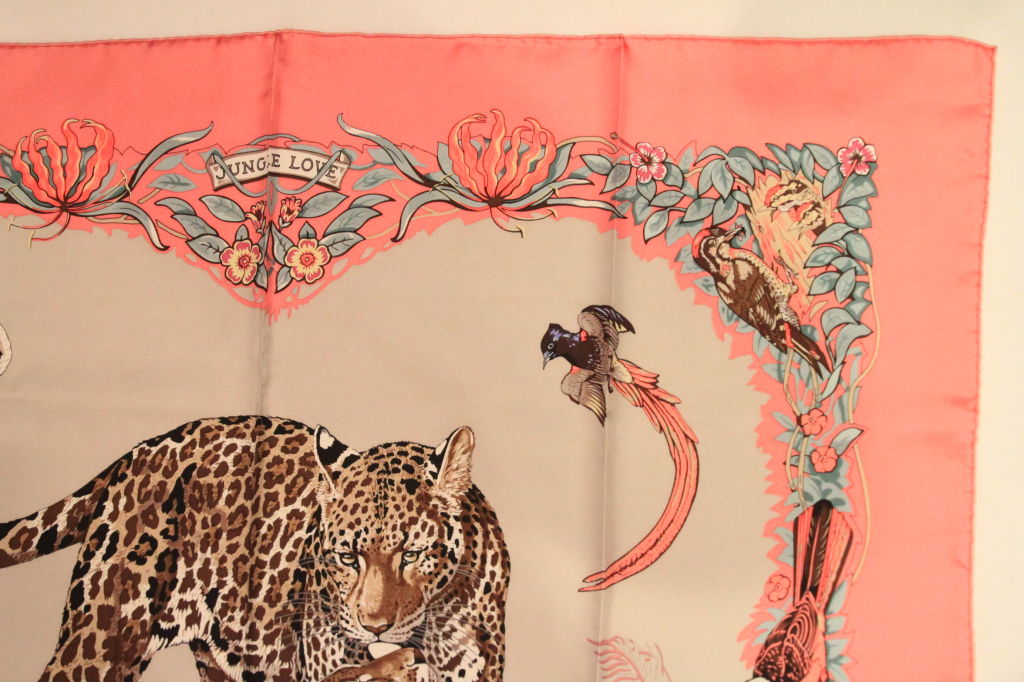 This Pink HERMES Jungle Love Silk Scarf is a classic addition to any wardrobe.<br />
<br />
The scarf is made of 100% Silk, hand-rolled. It can be used as a scarf or shawl. Join the ranks of royalty and celebs alike, all who have been photographed
