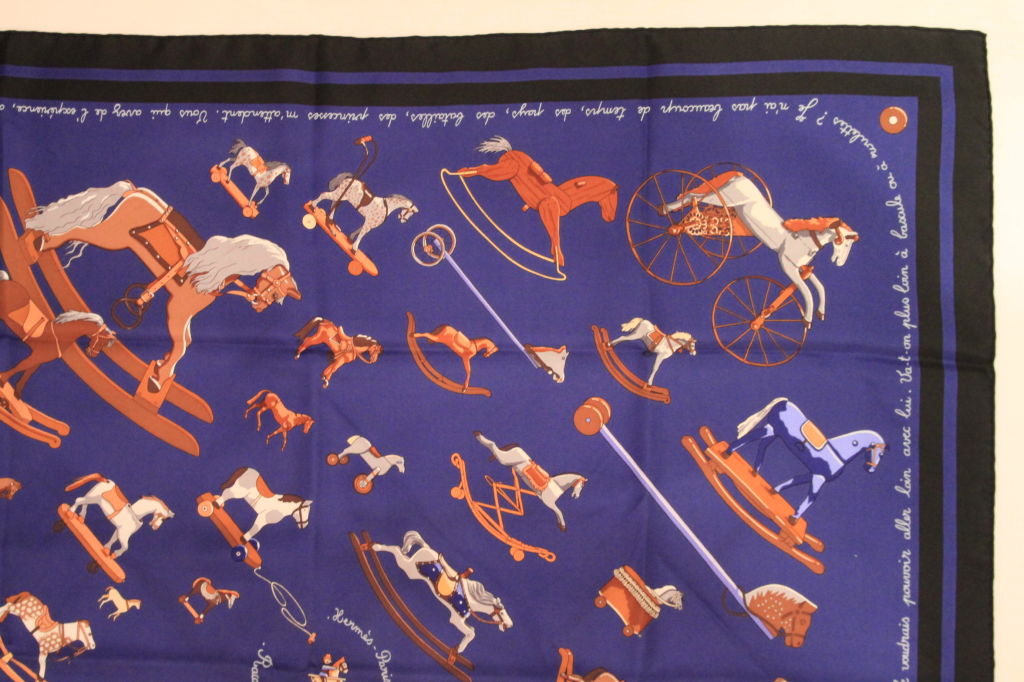 This Royal/Navy/Brown HERMES Rocking Horses Silk Scarf is a classic addition to any wardrobe.<br />
<br />
The scarf is made of 100% Silk, hand-rolled. It can be used as a scarf or shawl. Join the ranks of royalty and celebs alike, all who have