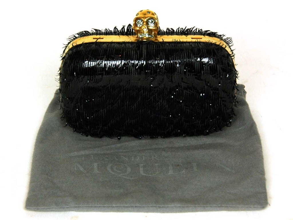 ALEXANDER MCQUEEN Black Frayed Patent Leather Box Clutch W. Skull Closure, Missing Chain RT. $1,695
Made in Italy
Materials: patent leather, goldtone metal, rhinestones, leather line.
Features rounded box clutch in frayed patent leather with