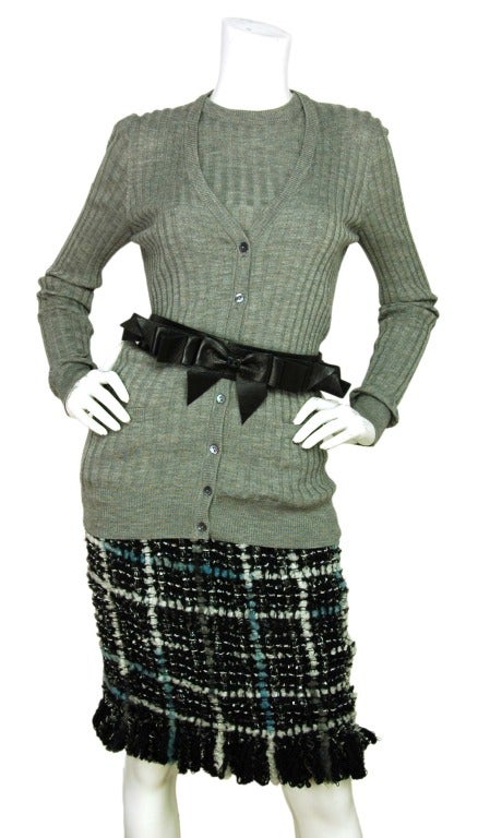 CHANEL Black, White, Blue & Grey Tweed Skirt W. Fringe Hem Sz. 38
Made in France
Materials: 65% wool, 16% acrylic, 12% polyester, 7% nylon, 100% silk lining.
Features black, white, blue and grey tweed skirt with fringe yarn hem. 

Marked size: