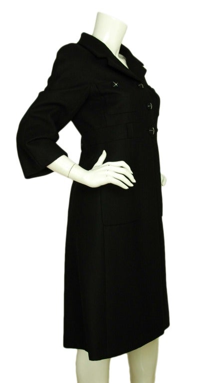 CHANEL Black Wool 3/4 Sleeve Coat W. Cross Buttons Sz. 40 c. 2007
Age: 2007
Made in France
Materials: 100% wool, lining: 100% silk.
Features collared, 3/4 sleeve jacket with three chain link cross & mini CC buttons. Two slip pockets on bust,
