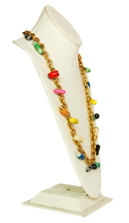 CHANEL Goldtone Chain Necklace W. Multicolor Pill Charms c. 1988
Age: 1988
Made in France
Materials: goldtone metal, assorted plastic pills.
Features strand of gold links with assorted dangling pills. Shuts via hook and eye closure.
Stamped