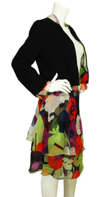 CHANEL Multicolor Floral Skirt W. Black Tweed Jacket W. Floral Lining Sz. 40
Materials: 75% polyester, 25% wool. Lining: 100% silk.
Features textured black jacket with multicolor floral lining and border. Circular Chanel logo button at wrist.