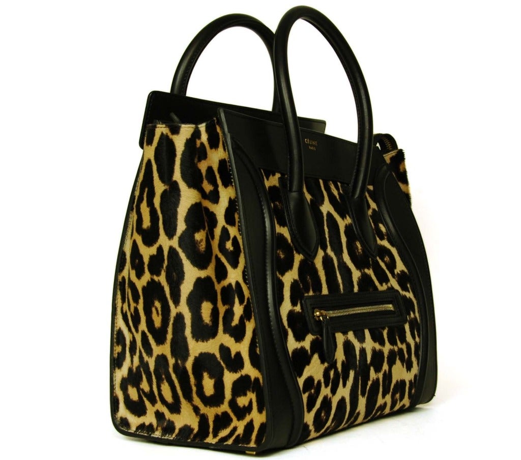 CELINE Leopard Print Ponyhair 'Mini Luggage' Tote RT. $4,400
Made in Italy
Materials: leather: 100% calfskin, lining: 100% lambskin.

Features classic luggage tote with winged sides. Black leather with leopard print ponyhair panels on front,