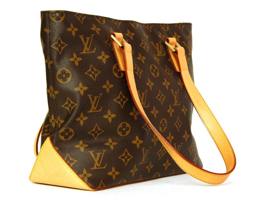 LOUIS VUITTON Brown Monogram Canvas 'Cabas Piano' Tote c. 2003
Age: 2003
Made in USA
Materials: coated canvas, leather, canvas lining.
Features double strap canvas tote bag in monogram print with natural leather straps and base. Brown canvas