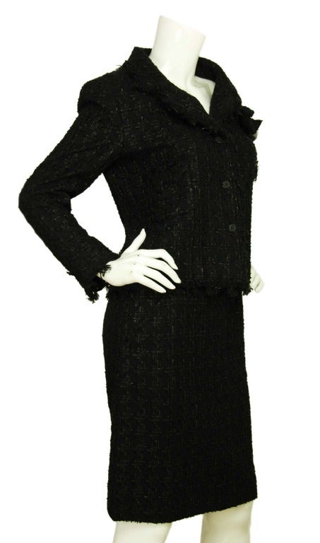 CHANEL Black Boucle Tweed Skirt Suit W. Camellia Pin & Belt Sz. 40 c. 2005
Age: 2005
Made in France
Materials: 52% cotton, 16% rayon, 12% acrylic, 9% spandex. Lining: 96% silk, 4% spandex.
Features collared, single breasted blazer in black
