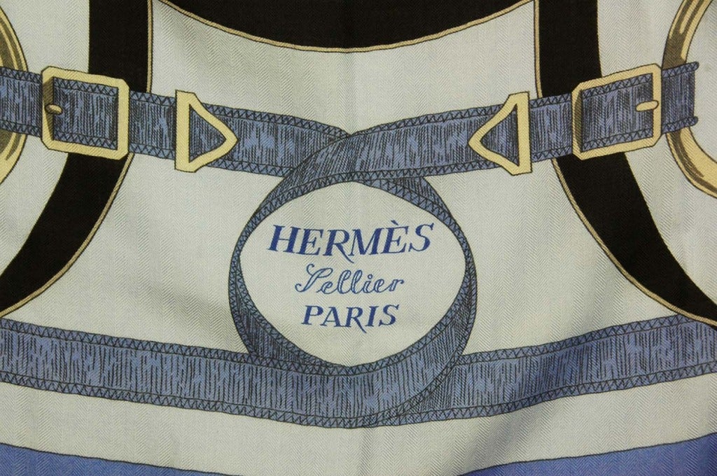 HERMES Blue & Orange Equestrian Print Cashmere Blend Scarf
Made in France
Materials: 65% cashmere, 35% silk.
Features square, cashmere blend equestrian print scarf in blue with grey, orange, black and white. Design features buckles and
