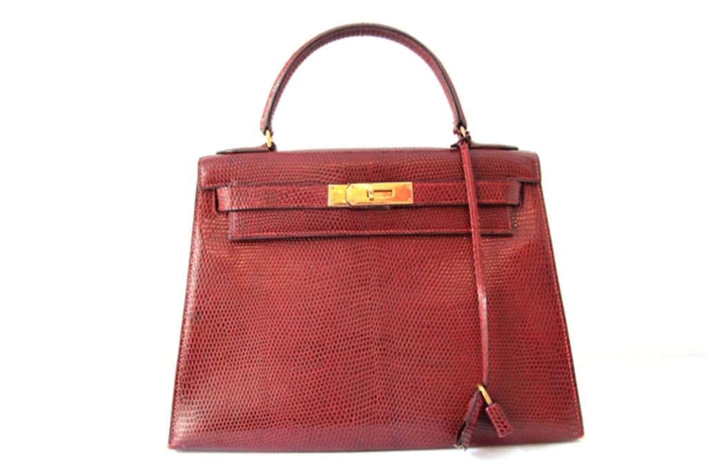 A timeless classic, this vintage Hermes Kelly Bag is a must-have addition to any Hermes lover's collection!<br />
<br />
Made in the most luxurious, burgundy exotic lizard with golden hardware.<br />
<br />
Top handle with front flap and twist