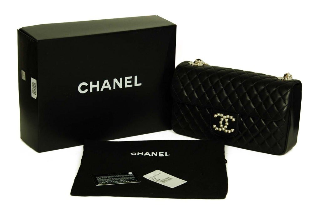 Chanel Black Quilted Lambskin Leather Westminster Flap Bag

Age: c. 2014
Made in Italy
Materials: leather, goldtone metal, faux pearls
Grey pinstriped fabric lining
Shoulder strap is made up of two stands of pearls, one strand of goldtone