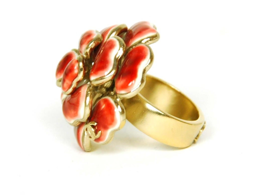 Chanel Red Enamel Camelia Ring

Age: c. 2008
Made in France
Materials: goldtone metal, red enamel
CC logo stamped on flower and band
Stamped 