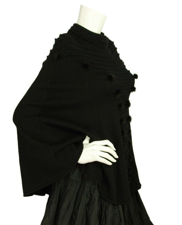 Fendi Black Cape With Mink Balls

Made in Italy
Composition: 85% wool, 10% mohair, 5% nylon 
Pullover cape features mink balls on front and back
Labeled 