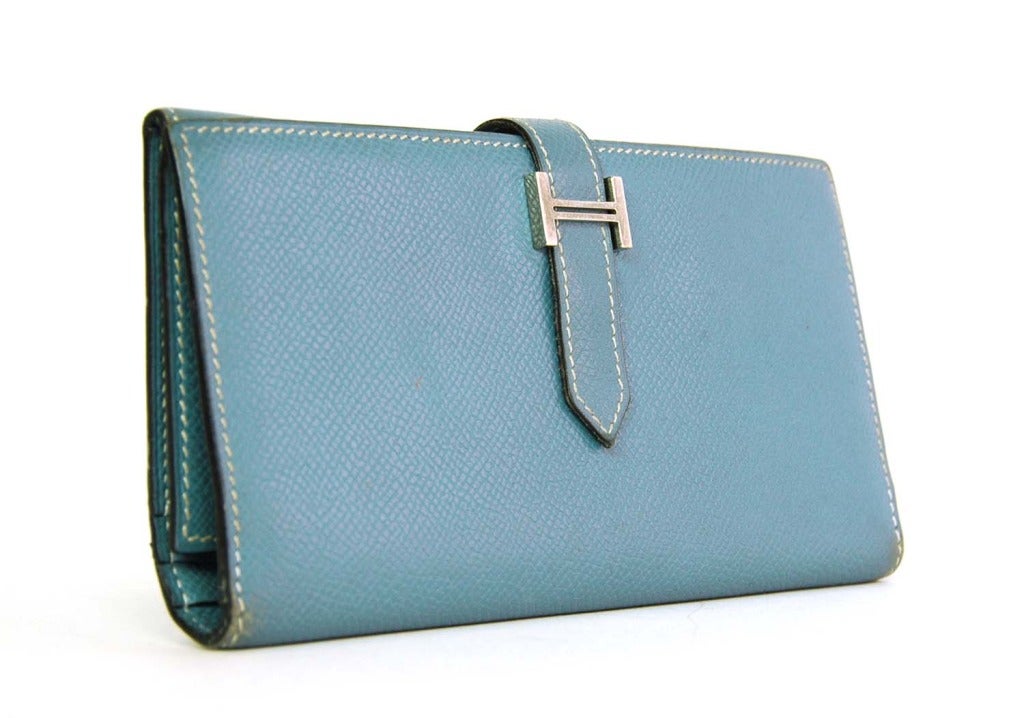 Hermes Blue Jean Epsom BEARN Wallet

    Age: c. 2006
    Made in France
    Materials: epsom leather, silvertone metal
    Ten card slots
    One zippered pocket and five open pockets
    Fold over flap and slide through silvertone H for