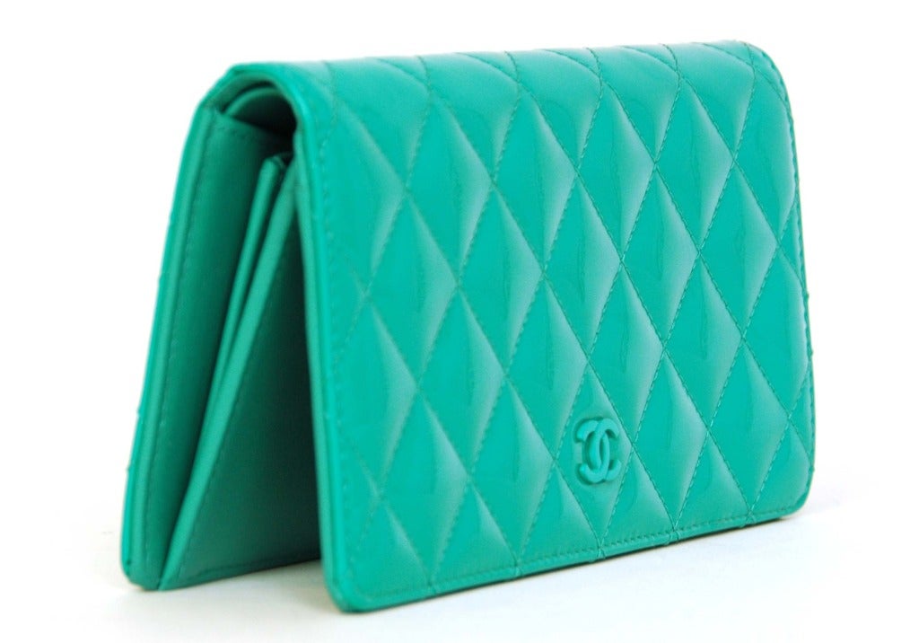 Chanel NIB Turquoise Quilted Patent Leather Long Wallet

    Age: c. 2013
    Made in Spain
    Materials: patent leather
    Half moon exterior slip pocket
    Eight card slots with two slip pockets underneath
    On opposite side there is a