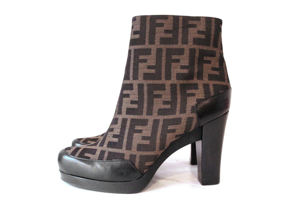 These timeless, classic FENDI Zucca Print Ankle Boots are the perfect addition to any wardrobe. It is made in zucca canvas with black leather trims. 3.5