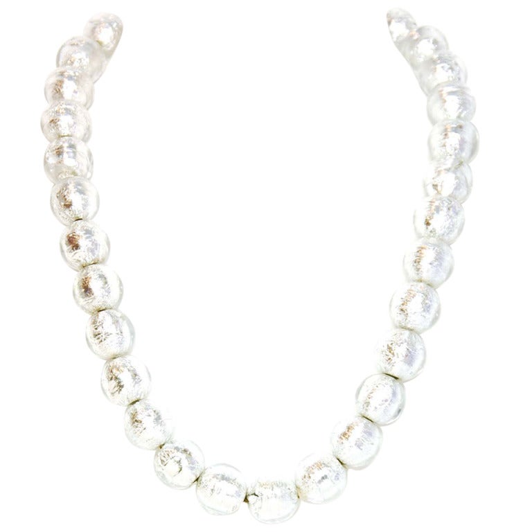 Chanel Clear Bead & Silver Foil Necklace
Features embedded silver foil inside of clear beads

Made In: France
Year of Production: 2000
Stamp: 00 CC c
Closure: Hook closure w/dangling CC charm
Color: Silvertone
Materials: Resin and metal
Overall