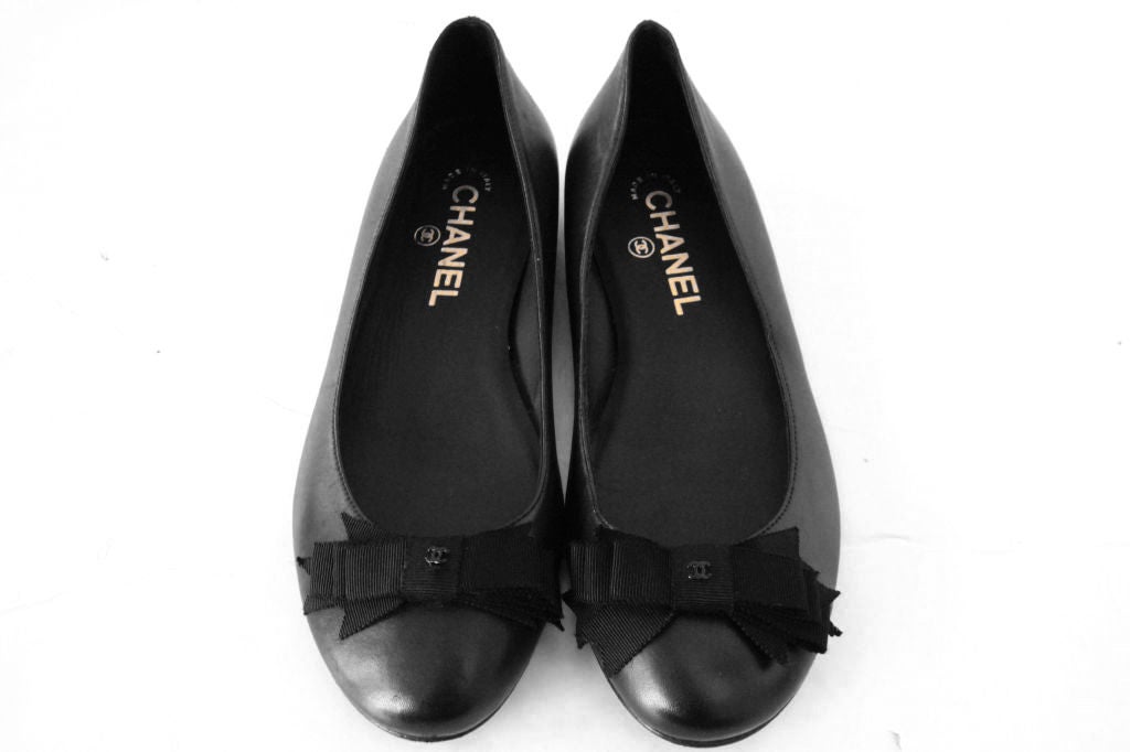 These CHANEL Black Leather Flats are the perfect must-have everyday shoes for all.<br />
<br />
These flats are made of black leather with fabric bow with hardware CC accented on the vamp.  Black leather insole stamped with 