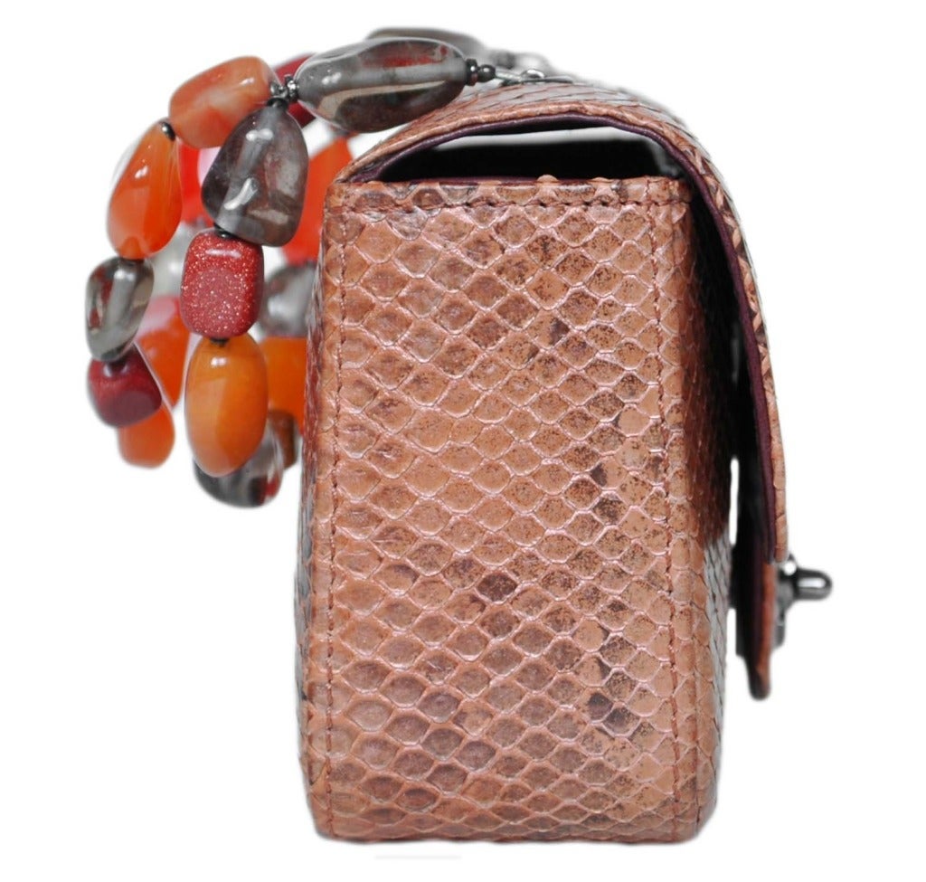 c.2003-2004
Made in Italy
Orange/peach python leather with silvertone hardware.
Front flap with signature CC twist lock
Brown leather lining
Orange and grey polished stone handle
Stamped CHANEL MADE IN ITALY
Hologram reads 8272881